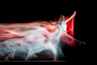 Digital composite image of women dancing against black background