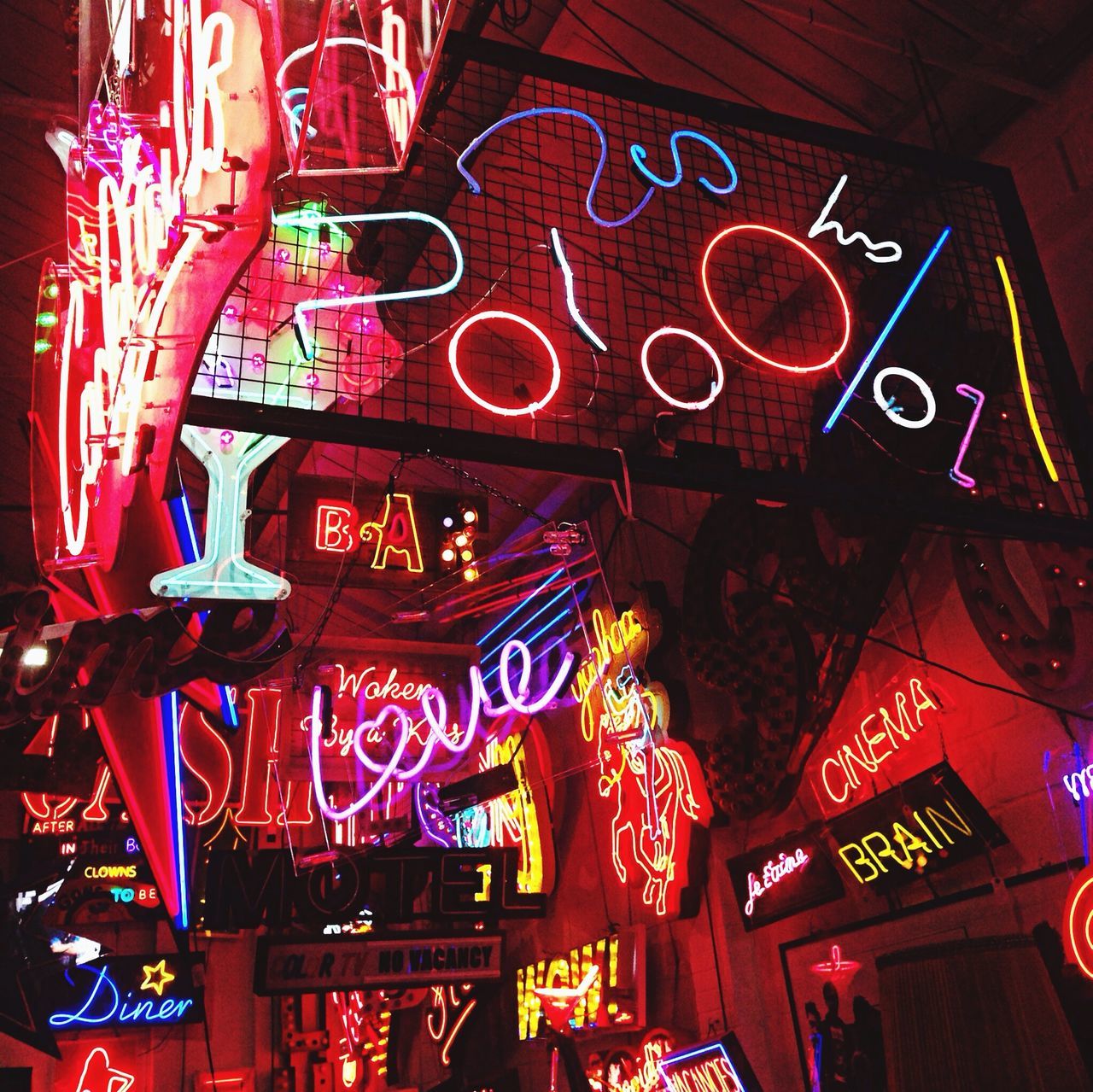 indoors, low angle view, illuminated, text, hanging, religion, art and craft, red, spirituality, place of worship, art, cultures, creativity, non-western script, tradition, lighting equipment, human representation, decoration, lantern, ornate