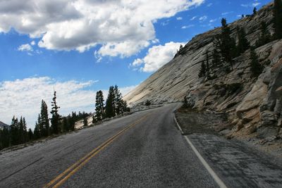 Road by mountain against sky