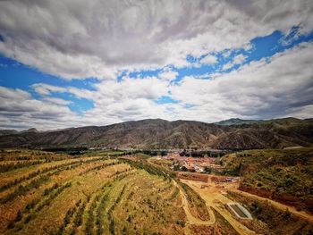 Scenic view of agricultural field against sky