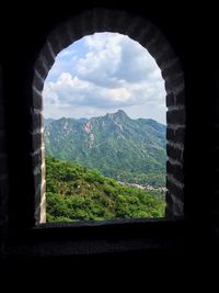 Scenic view of mountains against cloudy sky