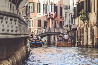 Bridge over canal amidst buildings in city