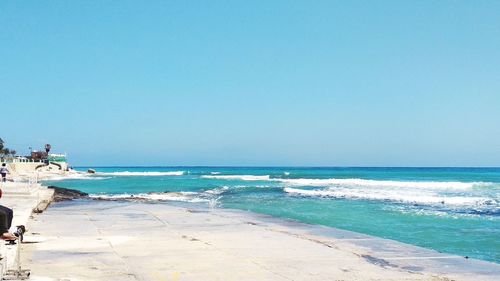 Scenic view of beach against clear sky