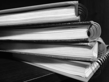 Close-up of stacked books over black background