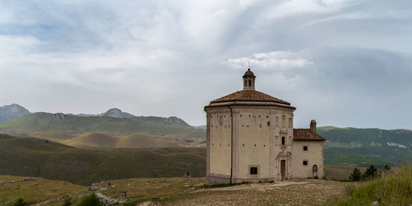 Historic building by mountains against sky
