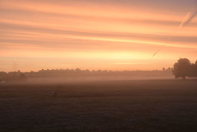 Scenic view of field against sky during sunset