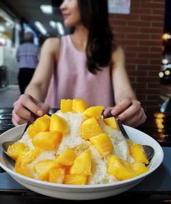 Midsection of woman with food in bowl