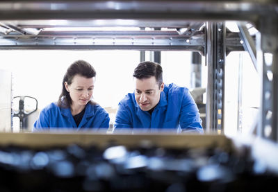 Male and female electricians working in industry