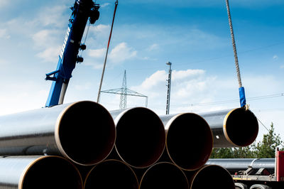 Low angle view of pipes against sky