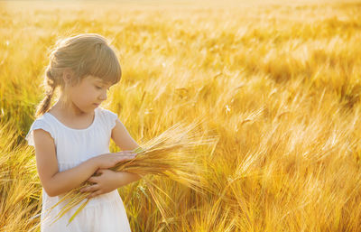 Portrait of young woman standing on field