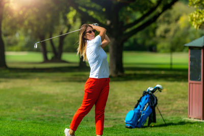 Woman playing golf. young female golfer on the tee box