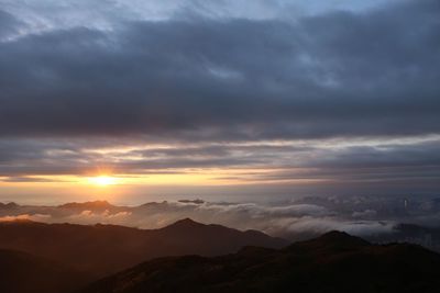 Scenic view of mountains against cloudy sky