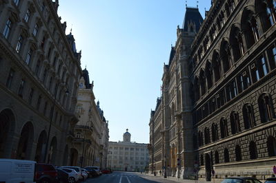 View of city street and buildings against sky