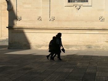 Rear view of man and woman walking