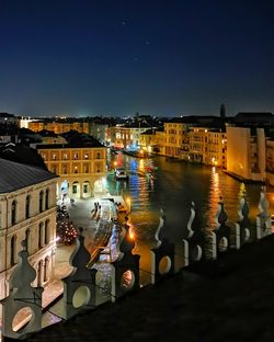 High angle view of illuminated buildings against sky at night