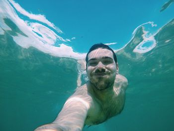 Portrait of man swimming undersea