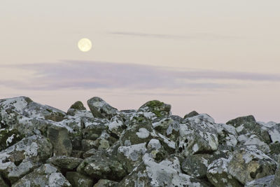 Scenic view of rock formation against sky at sunset