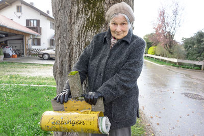 Portrait of a senior woman with letterbox