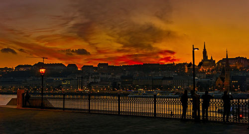 View of city at waterfront during sunset