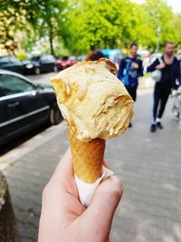 Cropped hand holding ice cream cone