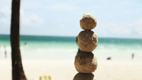 Stack on rocks at beach during sunny day