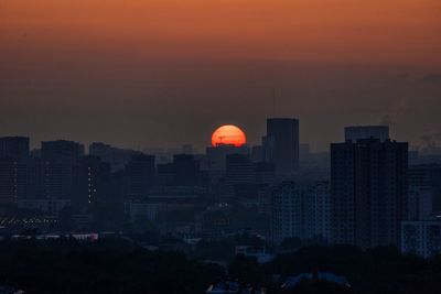 Low angle view of city at sunset