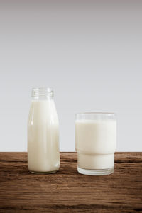 Close-up of drink in glass on table against white background