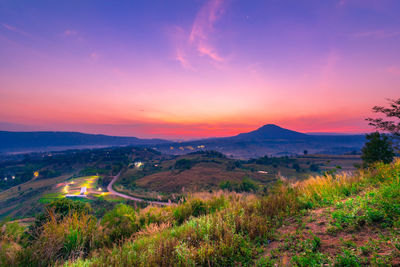 Scenic view of field against sky during sunset