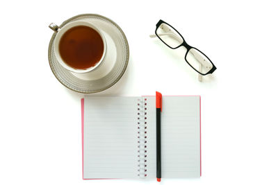 High angle view of coffee cup on white background