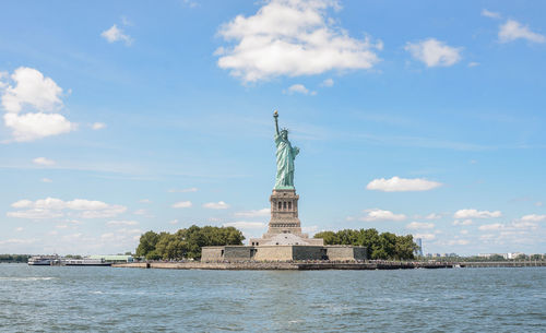 Statue of liberty against cloudy sky