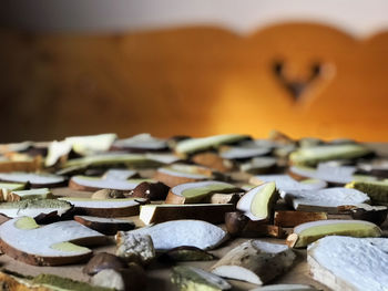 Close up/detail of sliced mushrooms on a table, wooden bench in the backround