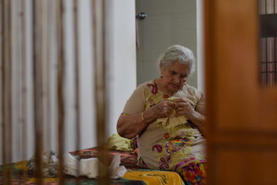 Senior woman sitting at home