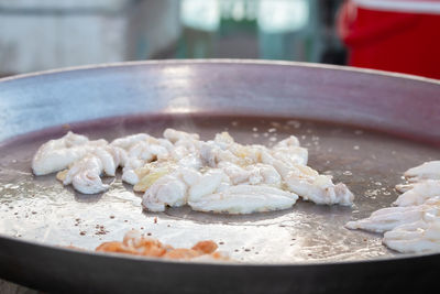 Close-up of meat in cooking pan on table