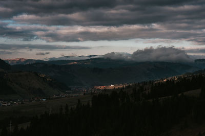 Trees and mountain against sky during sunset