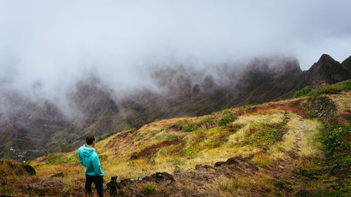 Rear view of man standing on mountain