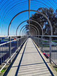Footpath amidst footbridge against sky