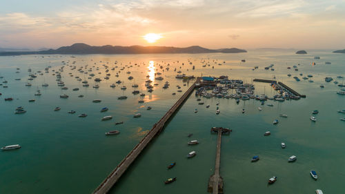 High angle view of boats in sea against sky during sunset