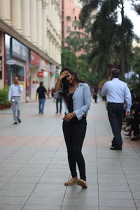 People walking on footpath in city