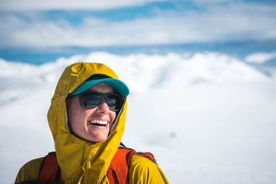 Woman laughing in winter with hood and hat one