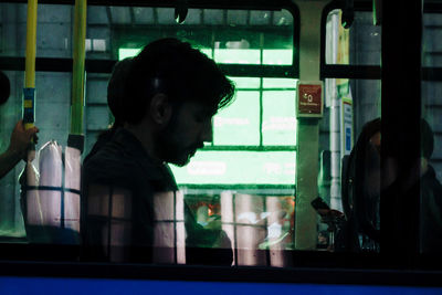 Portrait of man looking through window