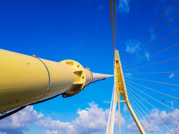 Low angle view of crane against blue sky