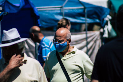 Portrait of man with people in background