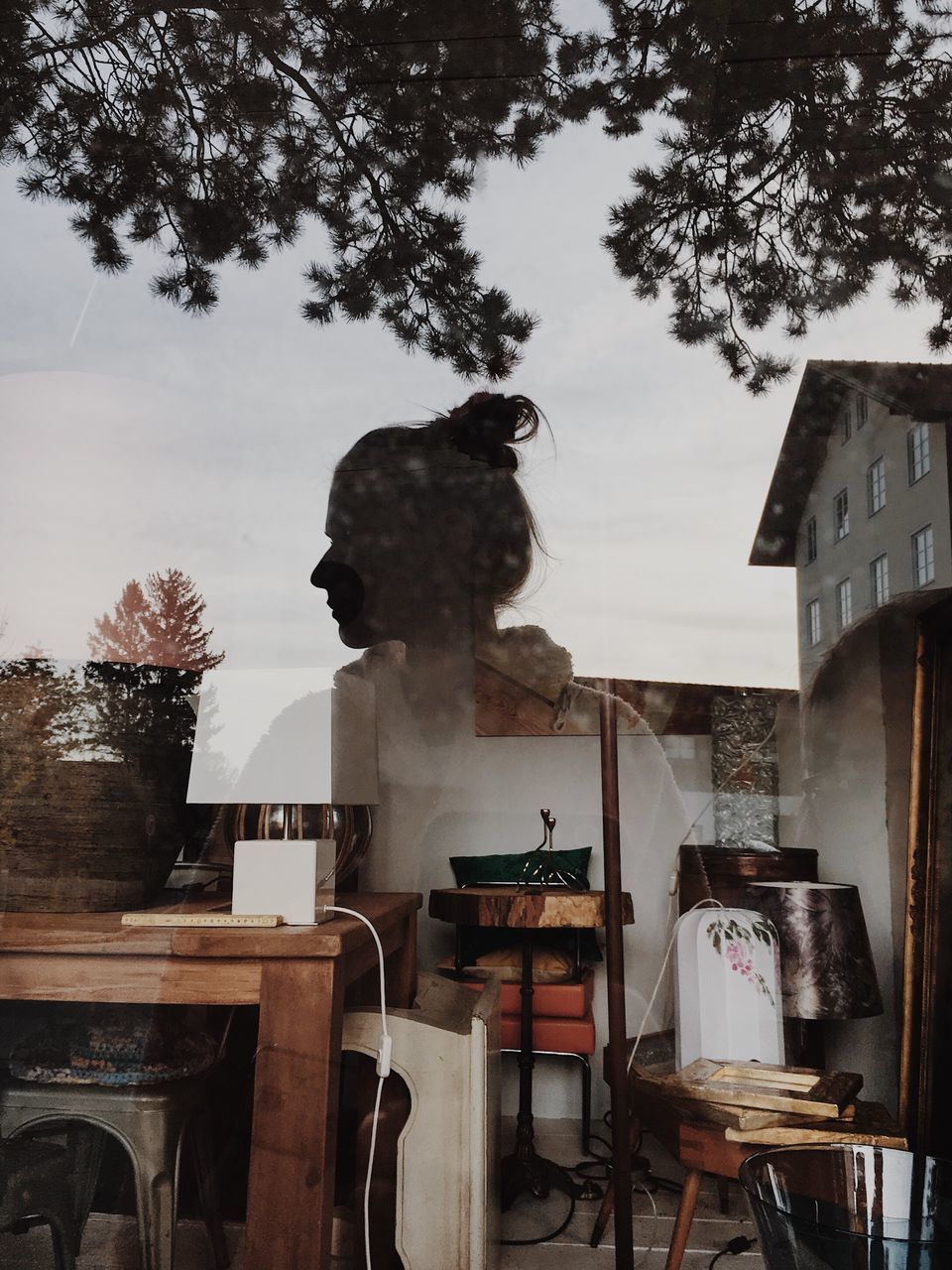 CAT ON TABLE AGAINST BUILDING