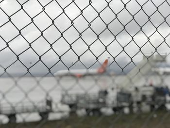 Close-up of chainlink fence against sky