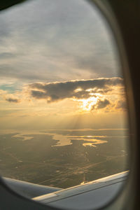 View of cloudy sky seen through airplane window
