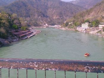 High angle view of ducks swimming in lake against mountains