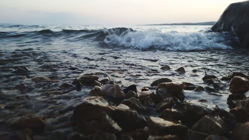 Rocks in sea against sky