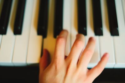 Close-up of hands playing piano