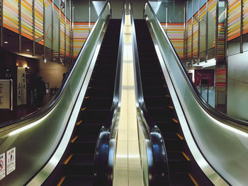 Low angle view of escalator in illuminated building