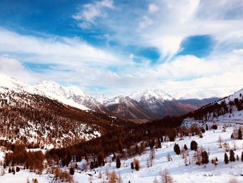 Scenic view of snow covered mountains against sky